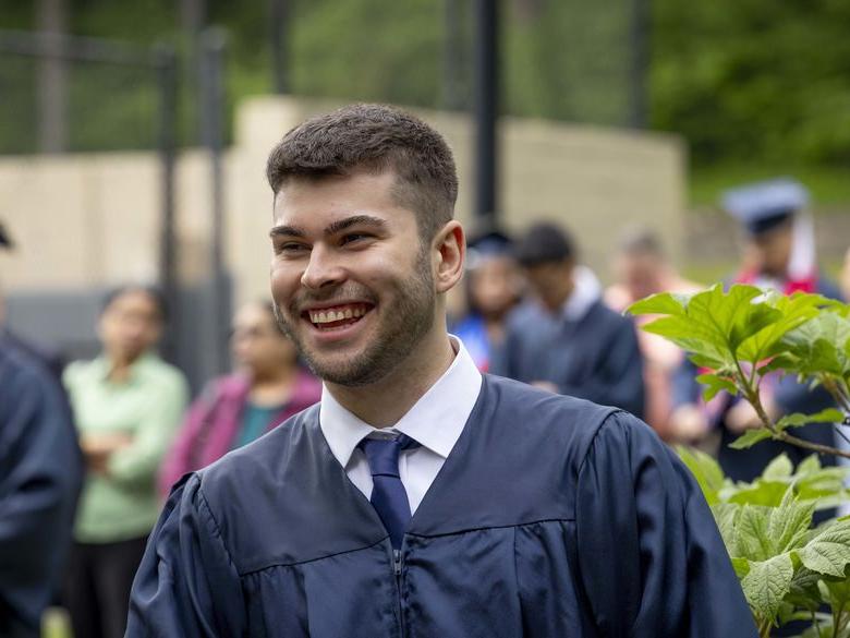 student outside after commencement 